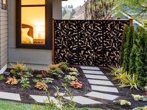 Garden screen installed against a backyard fence