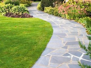 A paved walkway to a home