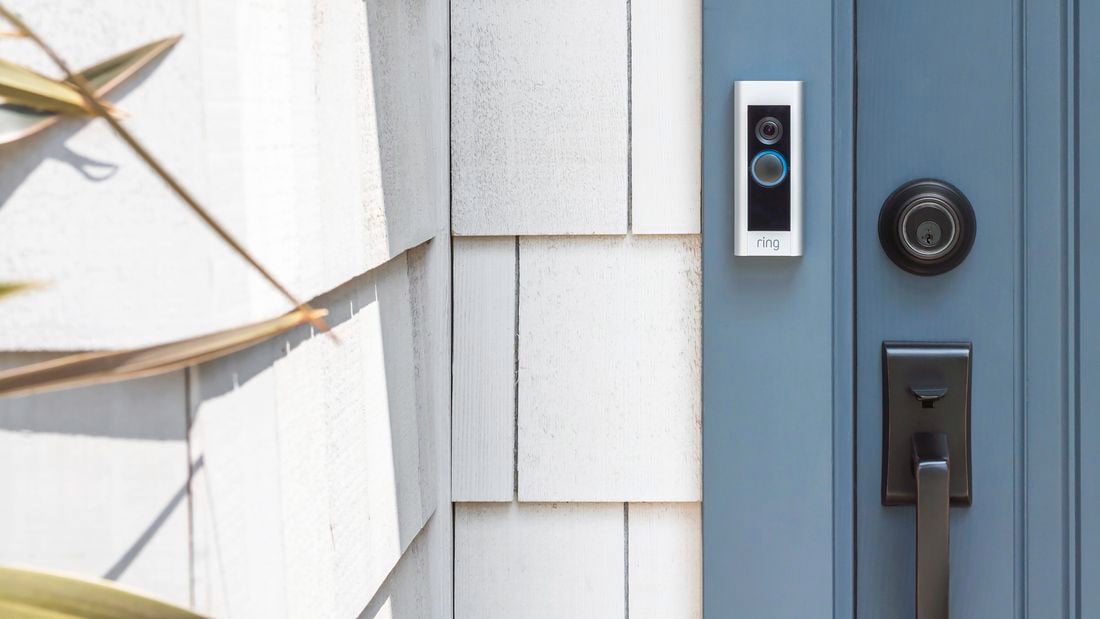 The front of a house with a blue door and doorbell