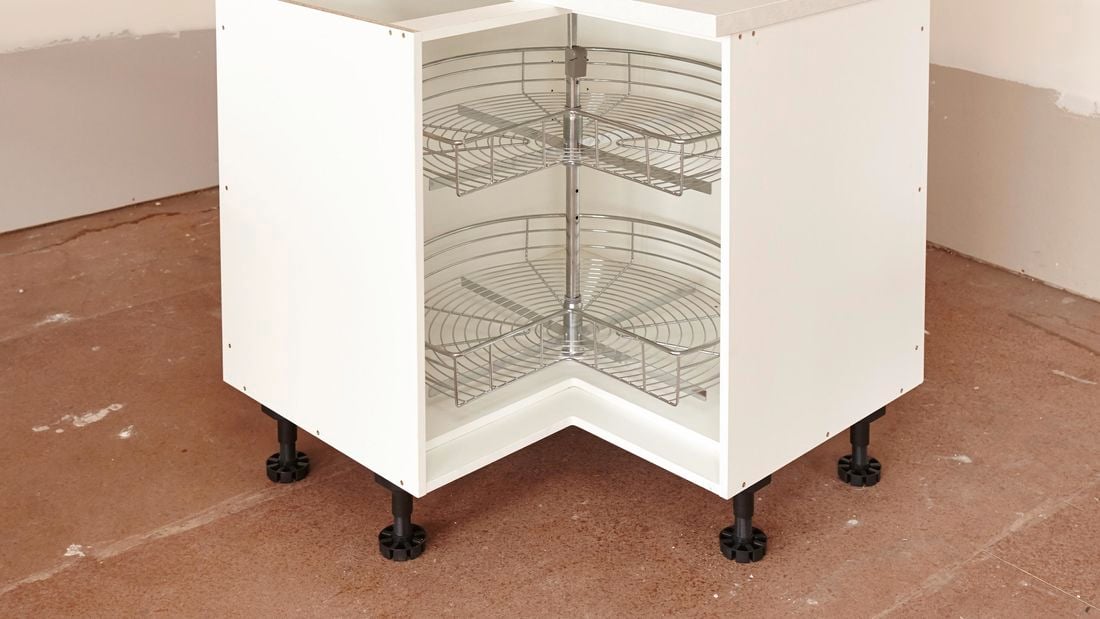 A corner cabinet unit with a two-tier rotating rack inside