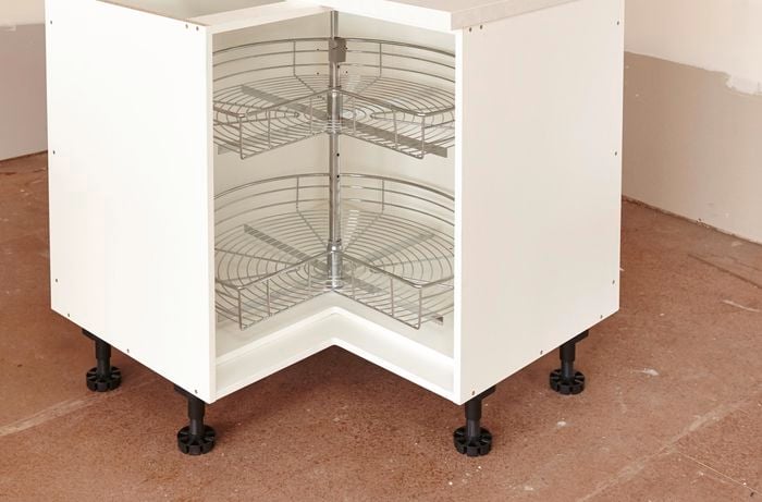 A corner cabinet unit with a two-tier rotating rack inside