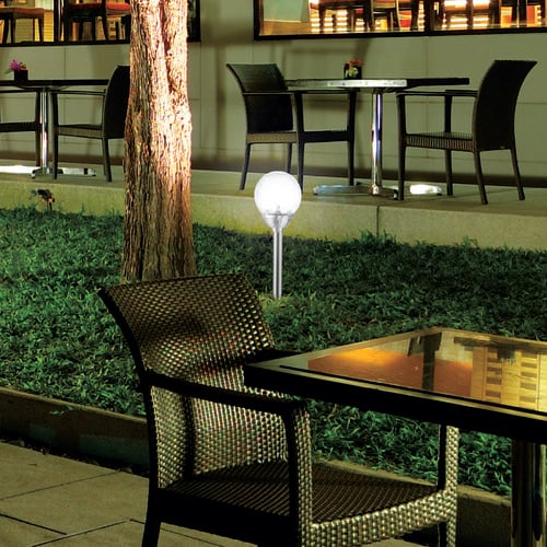 Garden light in a garden bed of an open air dining area