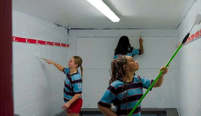Team painting the changerooms with a fresh coat of paint