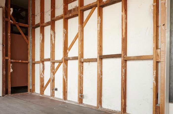 A stud wall frame with insulation removed