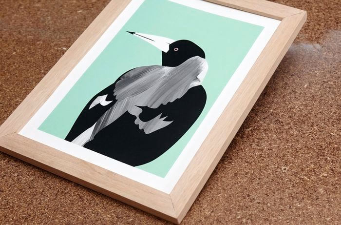A painted picture of a vicious magpie, mounted in a home-made wooden picture frame