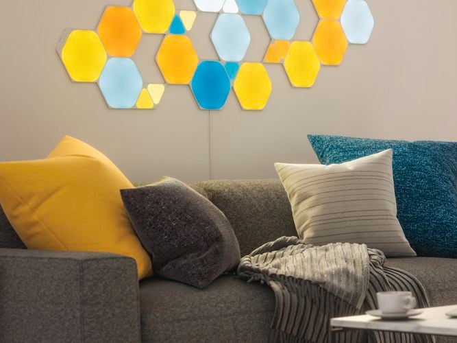 25 smart light panel layout mounted onto the wall behind a couch.