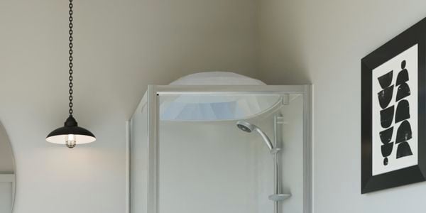 Modern white bathroom with black pendant lights and white tiled floor.