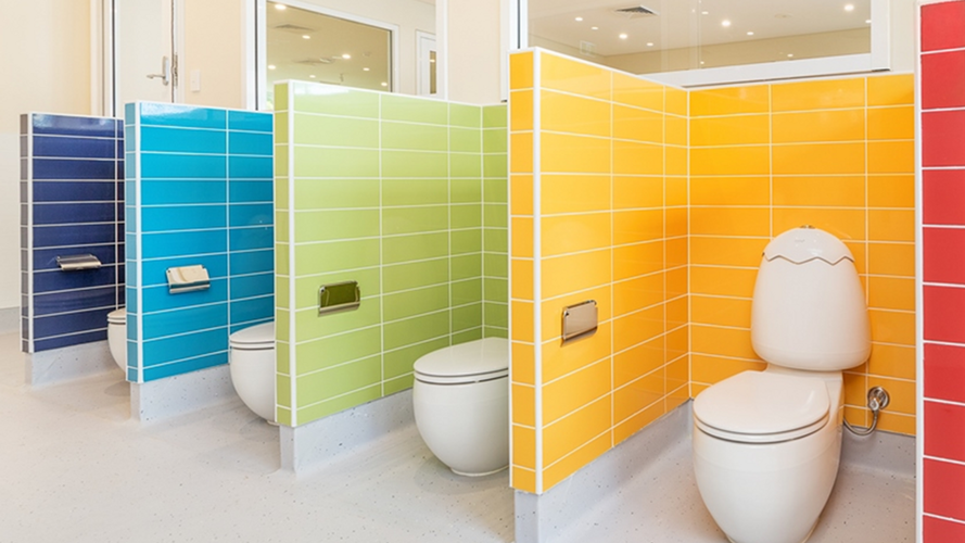 colourful tiled walls with kids toilets shwing
