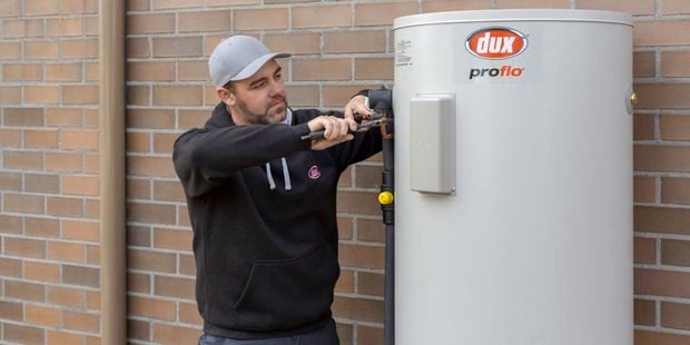 man fixing an electric water heater