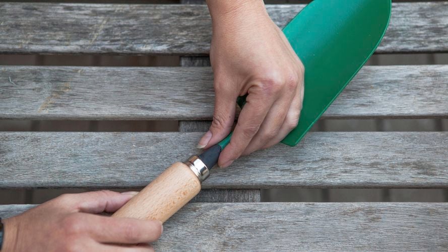 A person repairing a trowel.