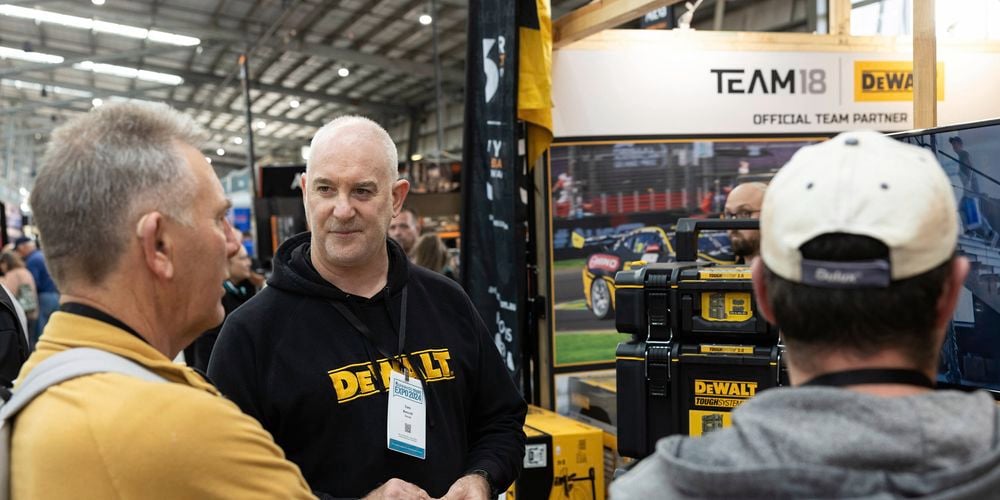 DeWALT stand at one of Bunnings trade expo events, DeWALT team member chatting with customers