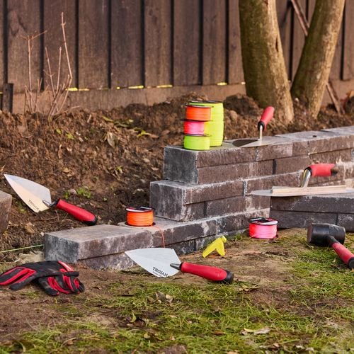 all the colours of the Trojan string line on bricks at a job site