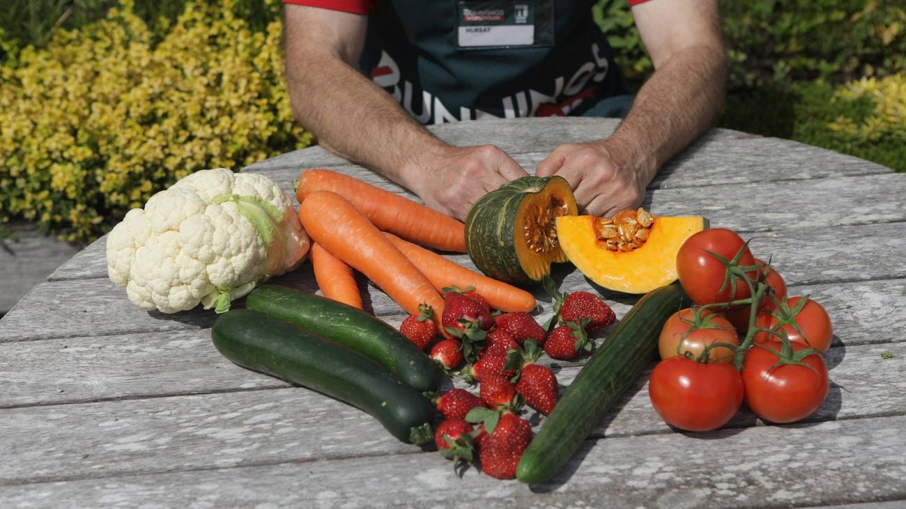 A collection of fruit and veg including carrots, strawberries and zucchini.