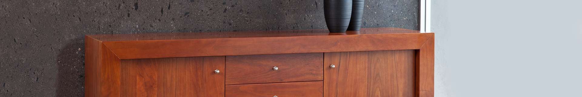 Wide wooden cabinet with a vase on top
