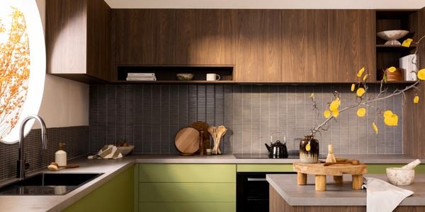 Dark wood and green kitchen with concrete benchtops
