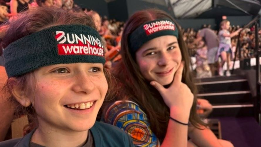 Kids wearing Bunnings headbands and watching basketball game