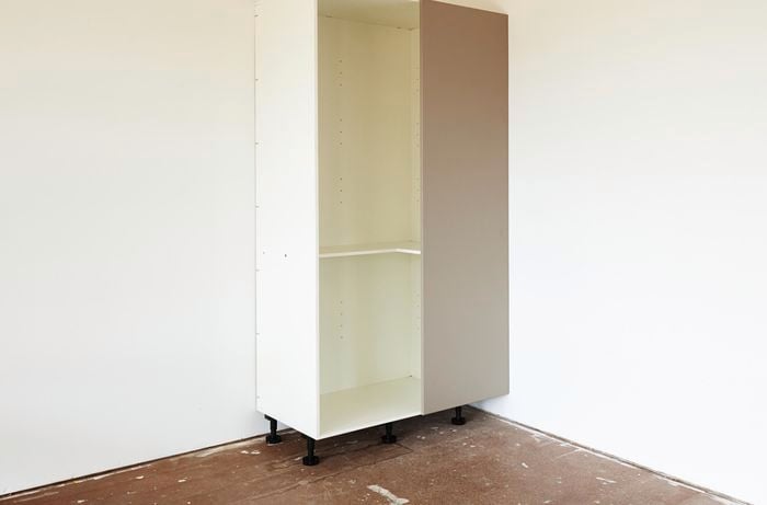 Completed white blind corner pantry in corner of room