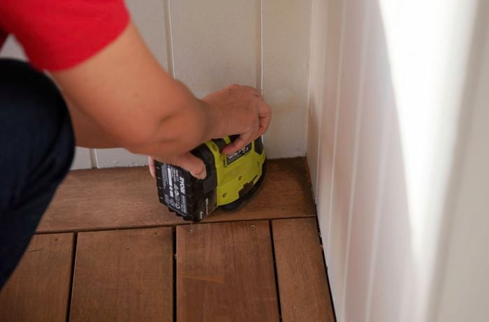 A close-up view of an edging sander is being used to sand ​edges and corner