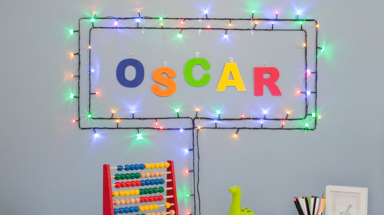 Child’s desk decorated with toys and coloured lights attached to the wall to make a sign