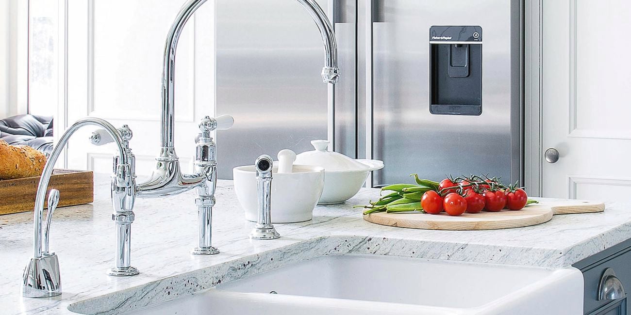Double under-mounted sink with marble benchtops and stainless steel taps