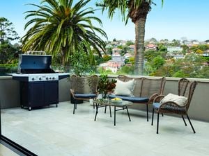 Table and chair set with BBQ on rooftop balcony