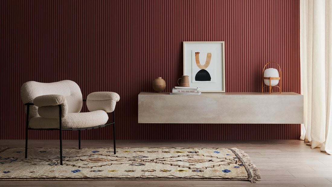 Living space with occasional chair, rug, concrete look floating shelf with accessories. Batten 25 design.