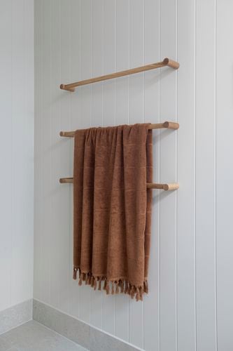 Towel rack with a brown towel with a wall painted using Coloursmith