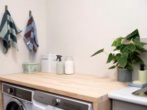 Space-saving laundry table installed over a washing machine and dryer