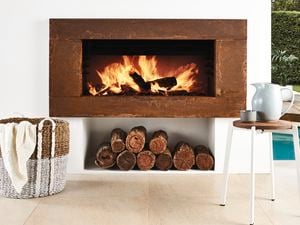 Fireplace with stack of wood.
