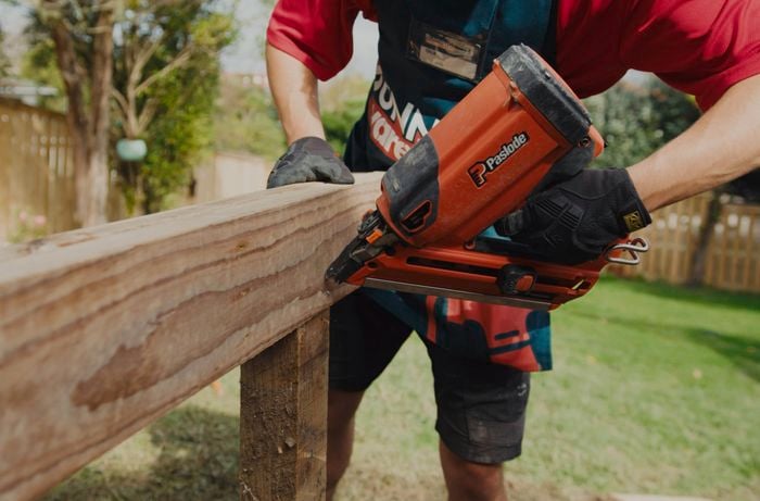 Bunnings team, member using a nail gun to put timber decking together