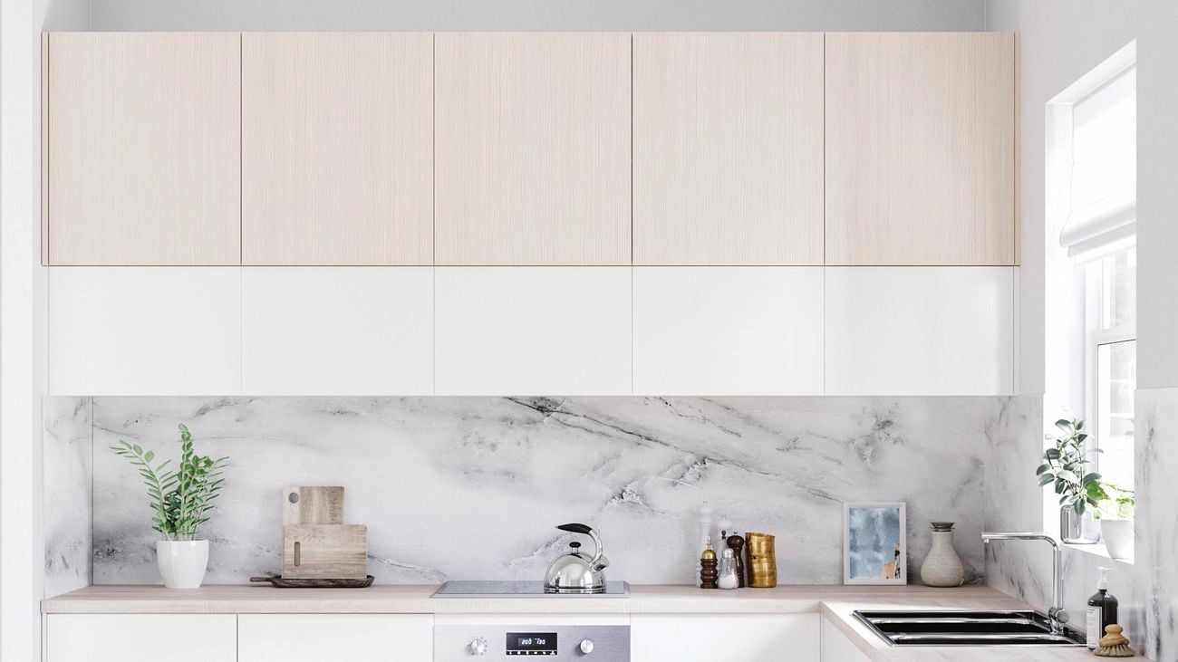 Kitchen with white and timber cabinets, timber benchtop and marble splashback.