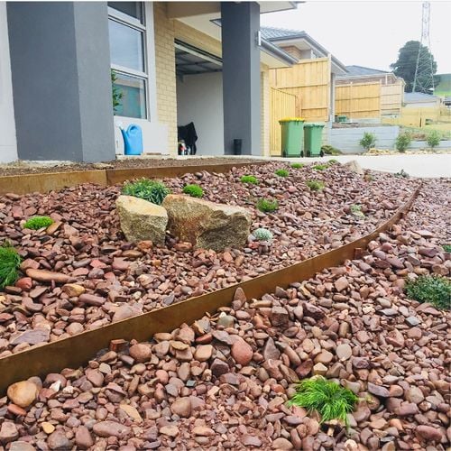 Front of home with pebble and stone garden