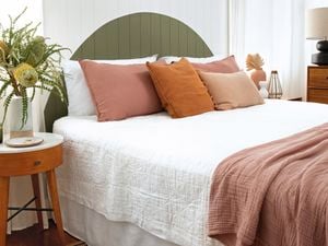 Bedroom with wall panelling painted to look like a headboard