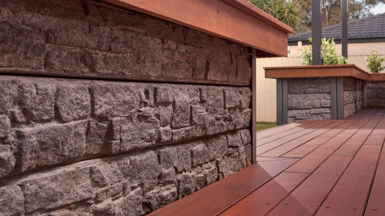 An image showing two timber capped concrete retaining walls built at the edges of a timber deck