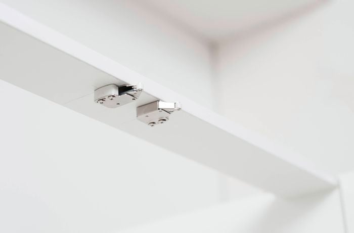 The image shows two push-to-open systems inside a cabinet.  