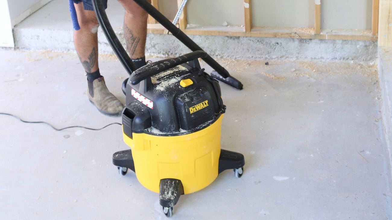 A close up image of a DeWALT wet and dry vacuum on a work site