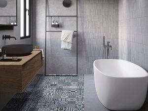Bathroom with dark tiles and and spanish pattern on floor