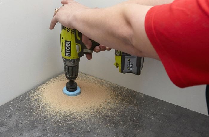 Using the hole saw to drill a hole in the back corner.