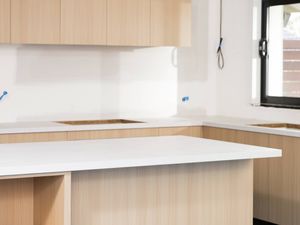 The image shows a freshly fitted kitchen with laminate benchtop.