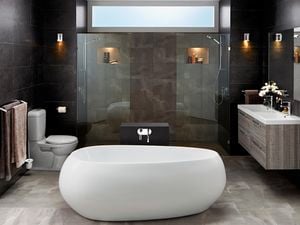 Modern bathroom with stand alone bath tub and marble walls