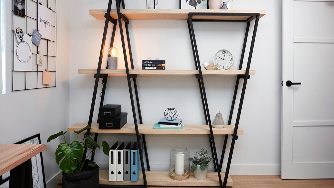 DIY industrial wooden bookshelf with various decorated items on it.