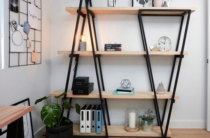 DIY industrial wooden bookshelf with various decorated items on it.