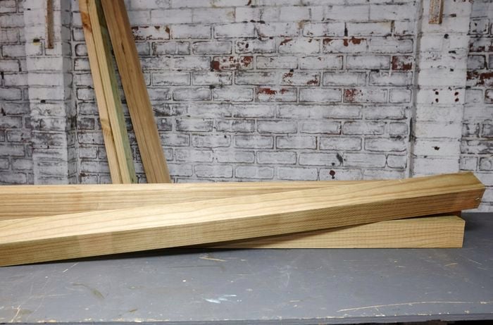 Pieces of long timber lying on the garage floor.