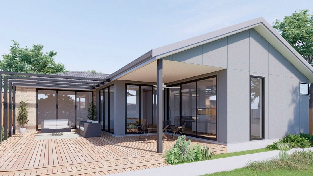 back garden with grey house and timber decking, plants and outdoor setting.