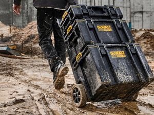 A man moving the ToughSystem stack on a muddy construction site.