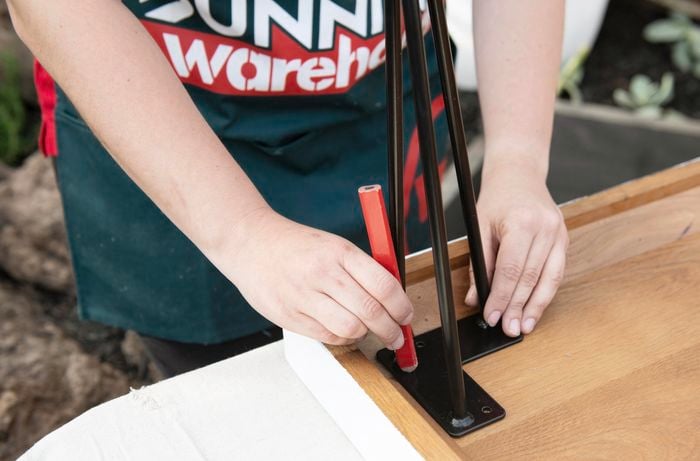 Person marking locations for replacement table legs