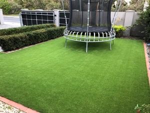 Synthetic turf and trampoline in front yard