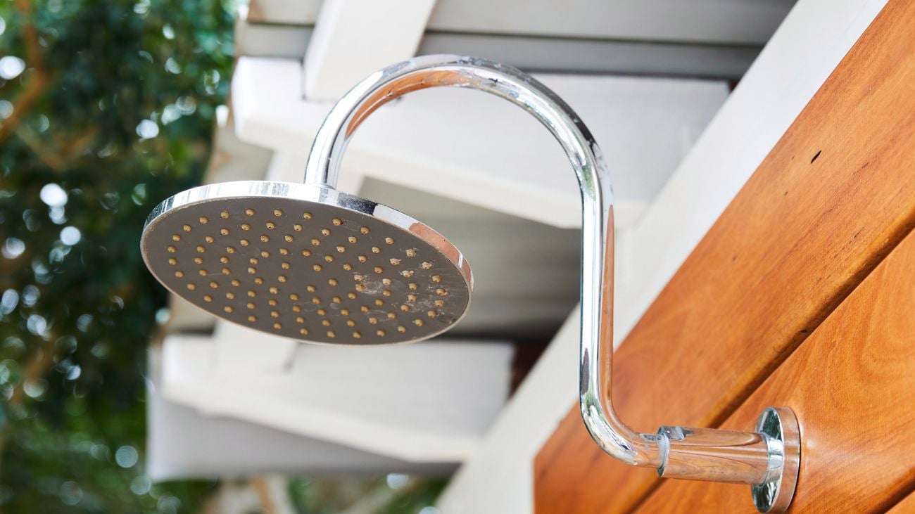 Close up shot of a silver, outdoor shower head.