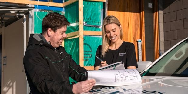 On a building site with Bunnings Trade team members, looking at the building plans.