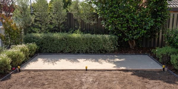 A prepared outdoor area features a leveled and compacted paver sand base 